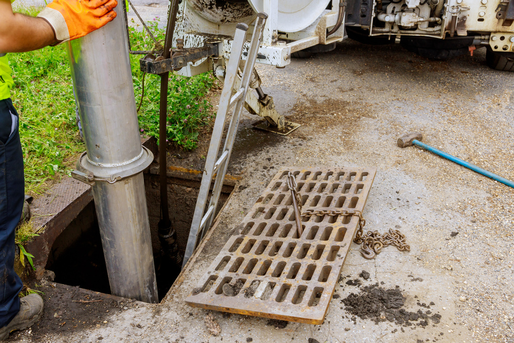 Sewage industrial cleaning truck clean blockage in a sewer line.